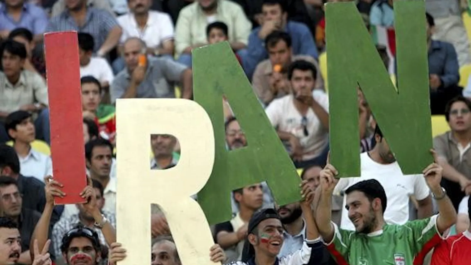 Fans paint their faces with the color of Iran's national flag in attendance of a freindly match between Iran and Bosnia-Herzegovina in Tehran May 31, 2006.