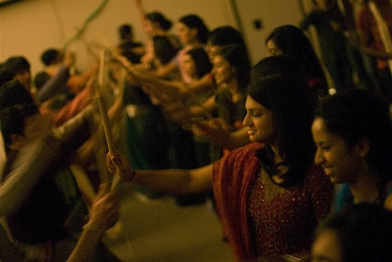 Members of the Indian Student Association dance Raas on Saturday night at the Bloomington Convention Center. The dance originates from Punjabi, a the northern region of India. The dance is performed in celebration of Navaratri, a nine-day festival venerating female divinites.
