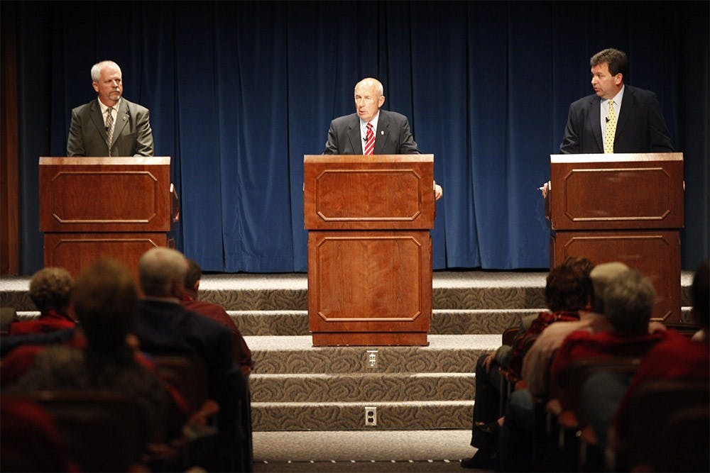 Philip N. Eskew Jr., middle, speaks during the question and answer section of the Board of Trustees trustee election forum while fellow trustees Dr. Jay Asdell, left, and Dr. Mike Wilcox, right, listen.  