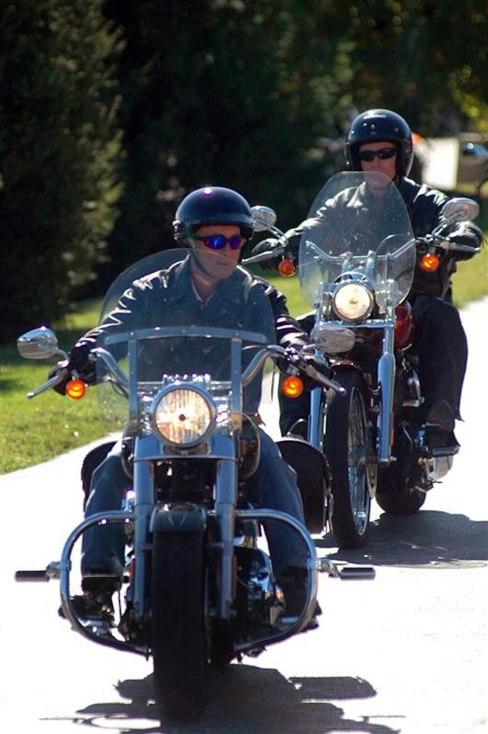 Gov. Mitch Daniels, left, leads a group of about 300 motorcycles into a Harley-Davidson dealership on Friday in Bloomington. Daniels rode with members of the American Bikers Aimed Towards Education on the ride, benefiting the National Guard Relief Fund.