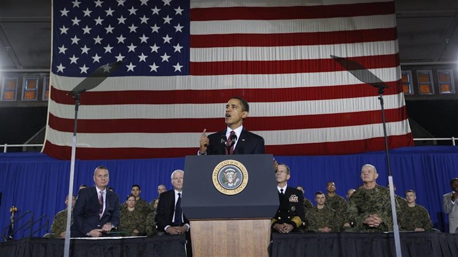 President Barack Obama speaks about combat troop levels in Iraq as he addresses military personnel Friday at Marine Corps Base Camp Lejeune, N.C. At rear are National Security Adviser James Jones, Defense Secretary Robert Gates, Chairman of the Joint Chiefs of Staff Adm. Mike Mullen, and Lt. Gen. Dennis Hejilik, Commanding General, Second Marine Expeditionary Force, Camp Lejeune.