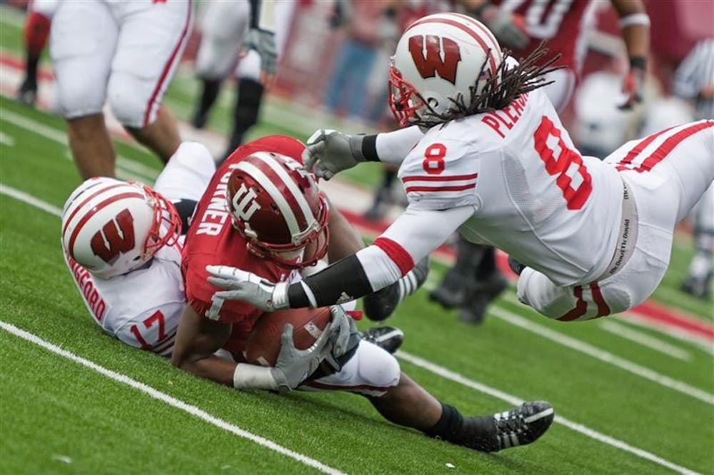 IU receiver Terrance Turner is tackled by Wisconsin's Mike Preisler (17) and Aubrey Pleasant (8) during IU's 55-20 loss on Saturday at Memorial Stadium.
