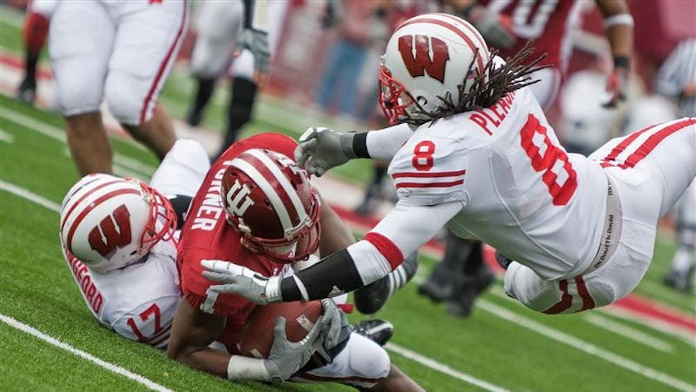 IU receiver Terrance Turner is tackled by Wisconsin's Mike Preisler (17) and Aubrey Pleasant (8) during IU's 55-20 loss on Saturday at Memorial Stadium.