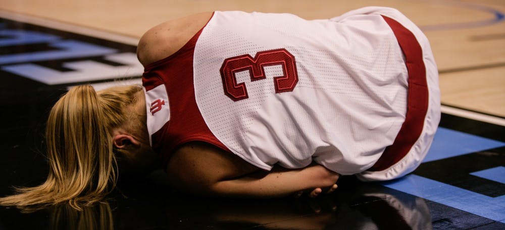 Sophomore guard Tyra Buss lies in pain after falling while attempting a layup. Buss scored 16 points for the Hoosiers, but they fell short and lost to Northwestern 73-79 Friday at Bankers Life Fieldhouse in Indianapolis.