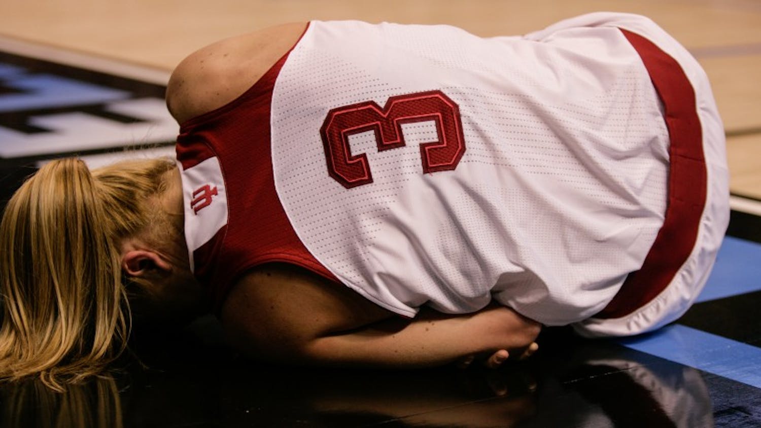 Sophomore guard Tyra Buss lies in pain after falling while attempting a layup. Buss scored 16 points for the Hoosiers, but they fell short and lost to Northwestern 73-79 Friday at Bankers Life Fieldhouse in Indianapolis.
