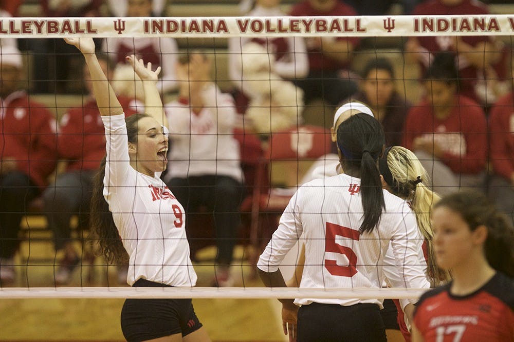 Members of the IU volleyball team celebrate after a point is scored during their game against Rutgers on Nov. 12 in University Gym.