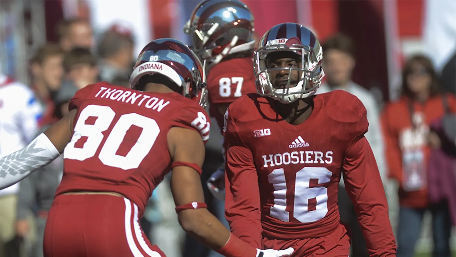 Cornerback Rashard Fant (16) high fives Leon Thornton III (80) before the game against Rutgers Saturday at Memorial Stadium. The Hoosiers lost, 52-55.