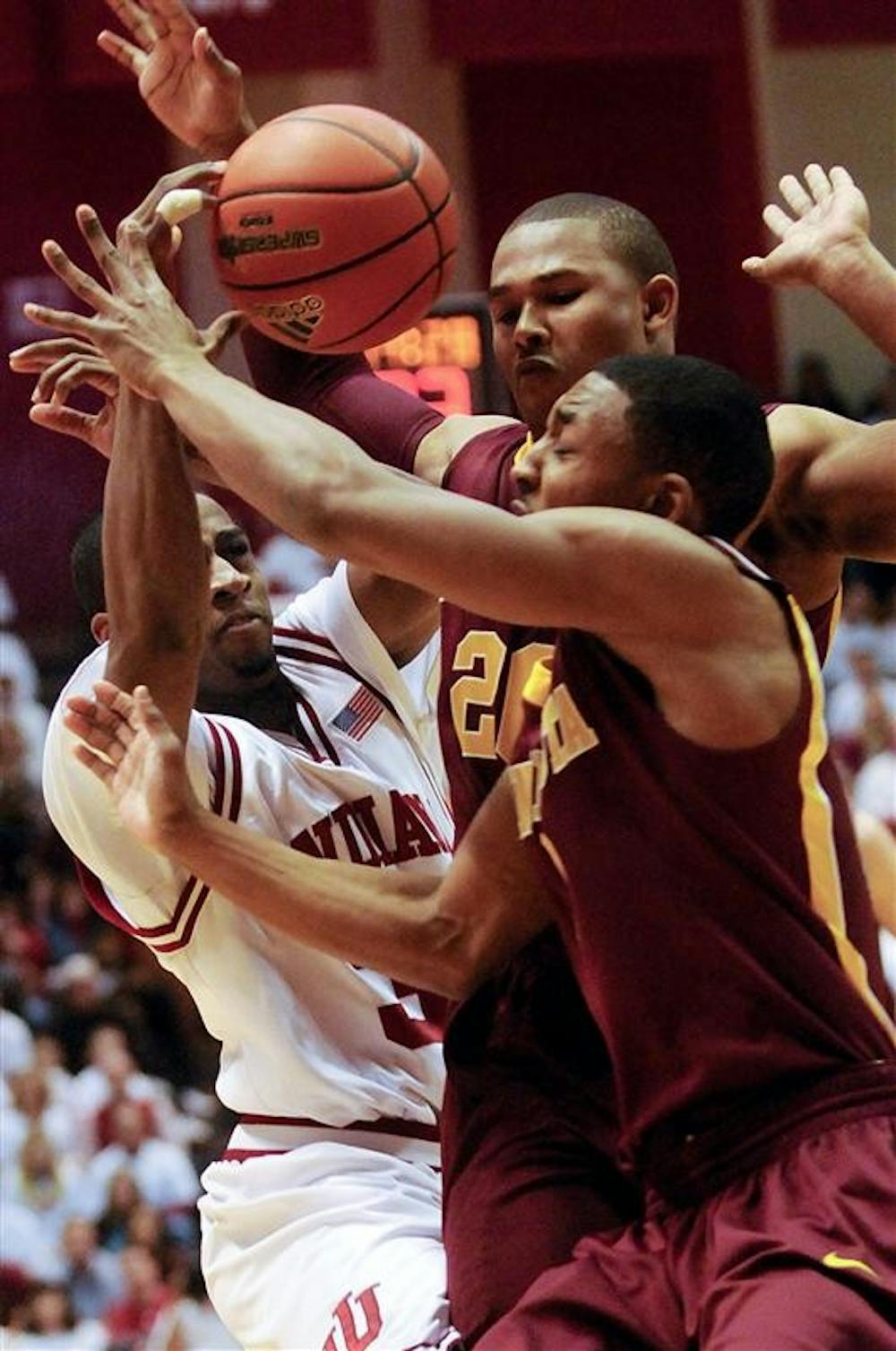 IU's Devan Dumes gets tangled up with two Minnesota defenders during the first half of IU's 67-63 loss to No. 21 Minnesota Sunday at Assembly Hall.