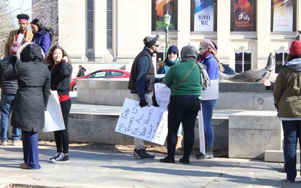 Demonstrators&nbsp;protest President Trump's recent executive orders at Showalter Fountain and carried&nbsp;signs like, "My faith teaches love for all, your policies don't-an American Muslim."