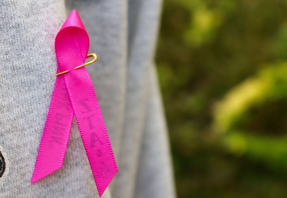 <p>A breast cancer awareness ribbon is pinned to a woman&#x27;s shirt Oct. 21, 2021. IU School of Medicine researcher Dr. Bryan Schneider is leading a new nationwide clinical trial to improve cure rates for patients with triple-negative breast cancer.</p>