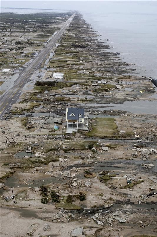With the Gulf of Mexico seen at right, a beachfront home stands among the debris on Sunday after Hurricane Ike hit the area in Gilchrist, Texas. Ike was the first major storm to directly hit a major U.S. metro area since Hurricane Katrina devastated New Orleans in 2005.