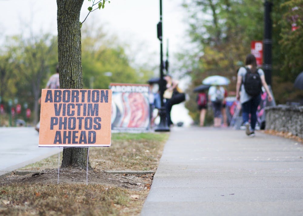 Signs protesting abortion line the intersection of 10th Street and Fee Lane on Oct. 4. The signs were placed as a collaboration between Students for Life at IU and Created Equal, an anti-abortion group based in Columbus, Ohio.