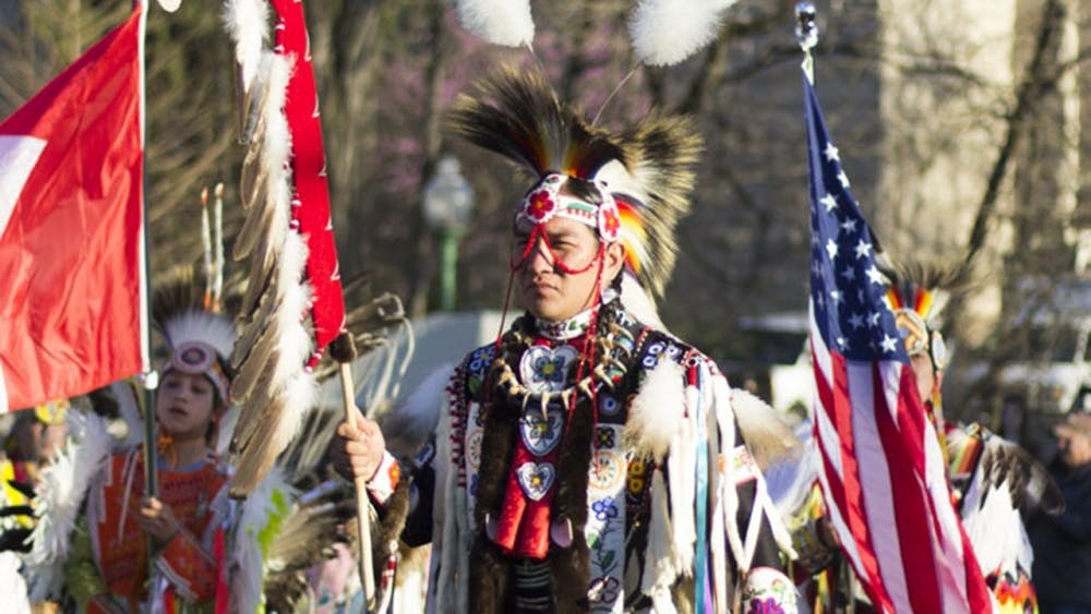 Performers stand during the First Nations Traditional Powwow on April 9, 2017, in Dunn Meadow.&nbsp;