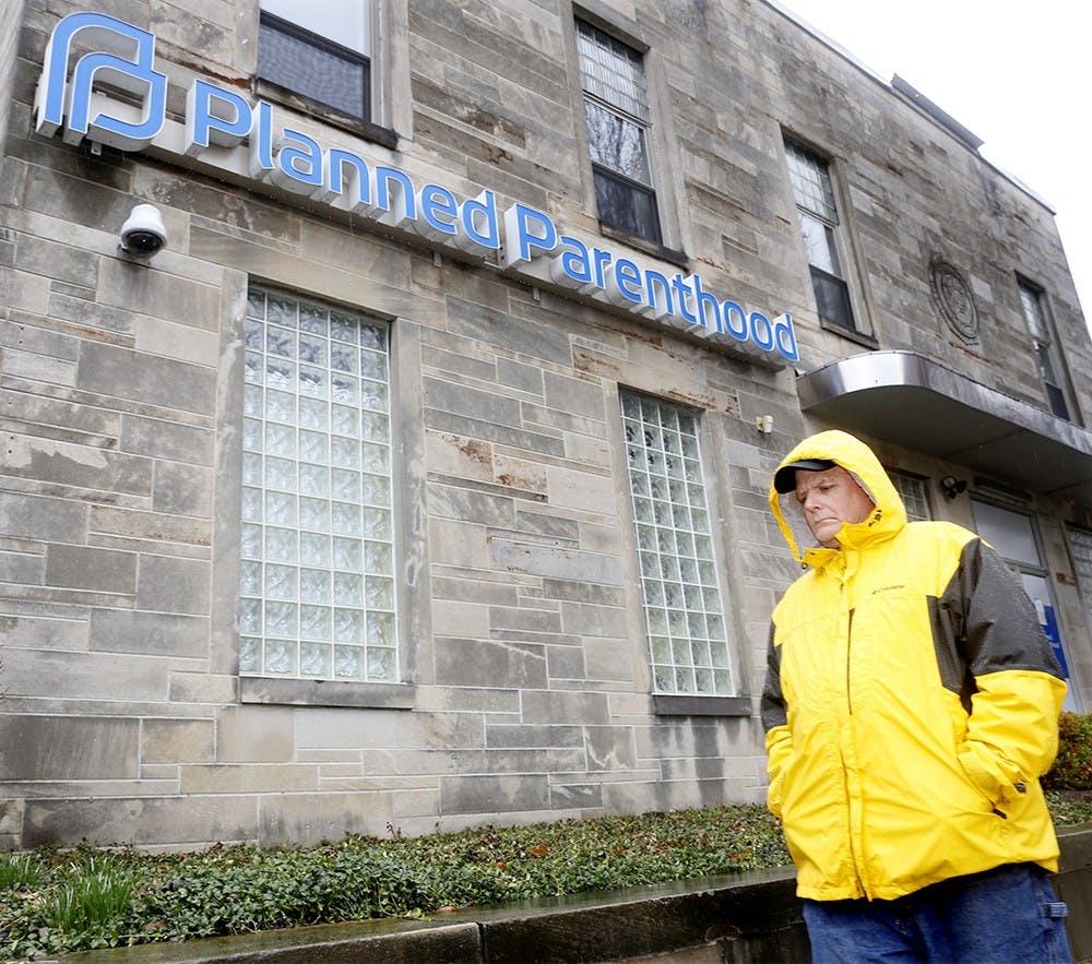 Peter Grant from Mary's Children Mother Of the Redemer, protests by walking around in front of Planned Parenthood Thursday. Prayers and protestors gather in front of the building every Thursday when abortion is proceeded. 