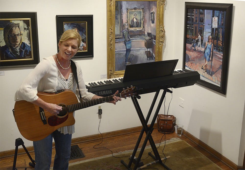 Cathy Gutjahr performs songs from her two released albums at The Venue on Tuesday Evening. Gutjahr moved to Bloomington after her husband’s job relocation and has since loved Bloomington. 