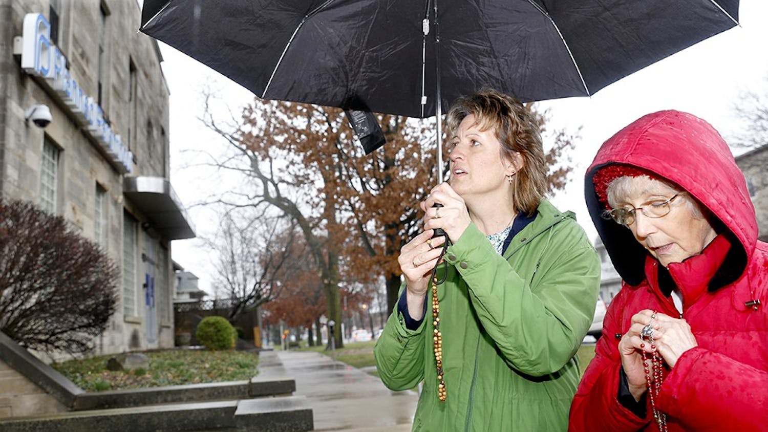 Brenda Preusz, left, and Barbara Dugan from Saint Bartholomew Catholic Church in Columbus, Ind. pray Thursday in front of Planned Parenthood. Prayers and protestors gather in front of the building every Thursday when abortion is proceeded. 