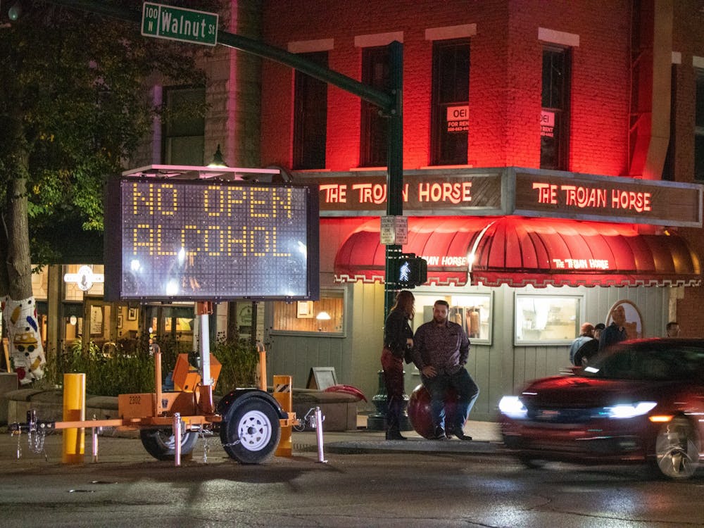 A large road sign is used while Kirkwood Avenue is closed to vehicles to remind visitors that open alcohol is illegal to have in public. People often hop between bars along Kirkwood and around downtown Bloomington, bringing their drinks with them at times.