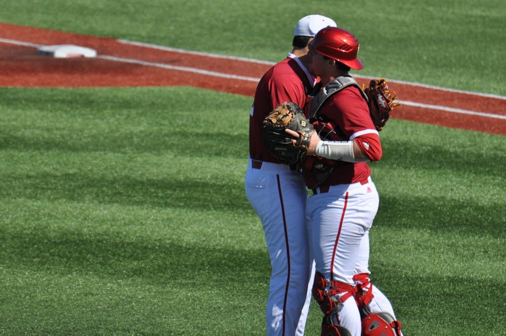 Junior pitcher Thomas Belcher and freshman catcher Ryan Fineman embrace after the final out of Indiana's 3-2 victory over Purdue on Sturday at Bart Kaufman Field.