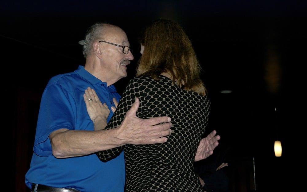 David Crosley, a tango instructor from Indianapolis, dances with Heather Maritano, 49, at the tango beginner class at Serendipity Martini Bar Monday night. Tango emphasizes a connection between partners and with the music. For Maritano, tango is “all about communication.”
