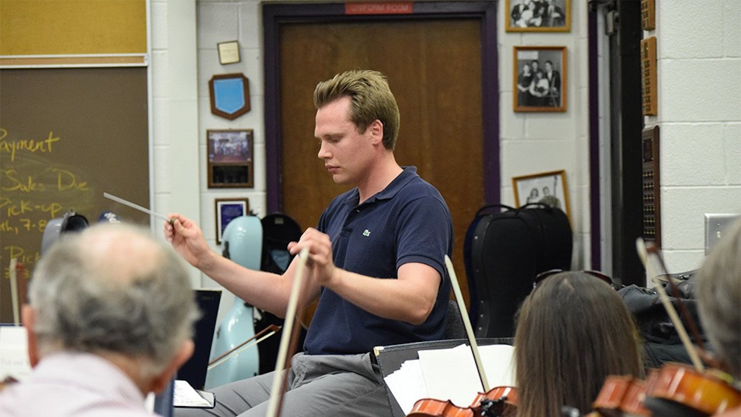 Artistic director Adam Bodony conducts the Bloomington Symphony Orchestra in a string rehearsal Sept. 15, 2015, in the orchestra room of Bloomington High School South.