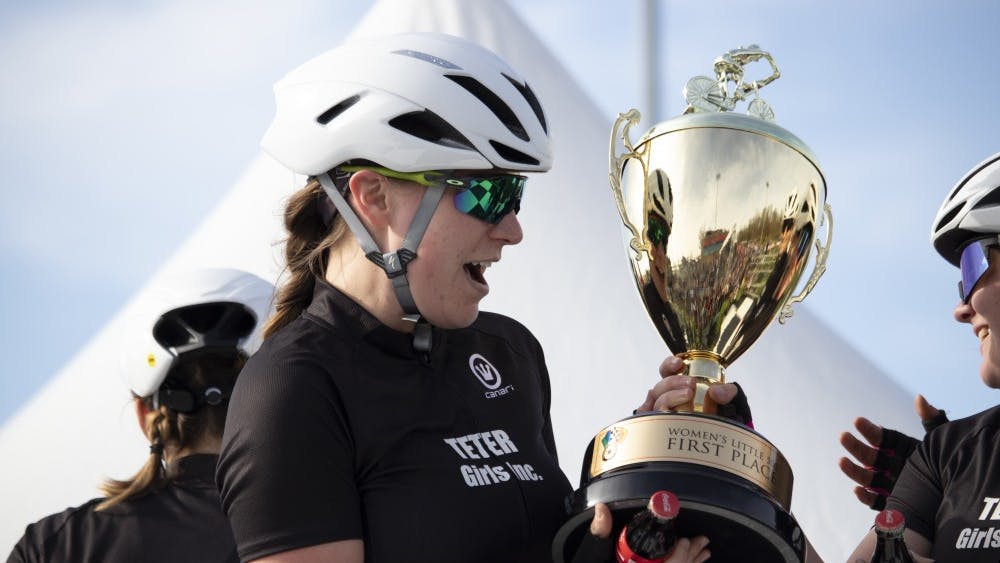 A member of Teter Cycling gasps at her team’s first place trophy April 12 at Bill Armstrong Stadium. The team beat Delta Gamma and SKI in the final laps.