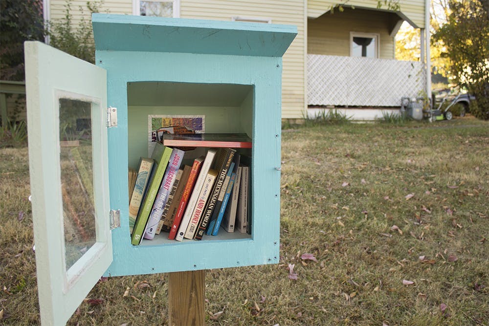 A Little Free Library full of books sits on Madison Street near Kirkwood Avenue. These sorts of libraries have been popping up since 2009, and recently started to get built in Bloomington in 2013.