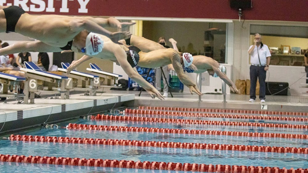 Indiana University and University of Cincinnati swimmers dive into the water during a duel meet on Dec. 3, 2021, at the Consilman-Billingsley Aquatic Center. Indiana men and women&#x27;s swim and dive will face Purdue at 10 a.m. Saturday at IU.