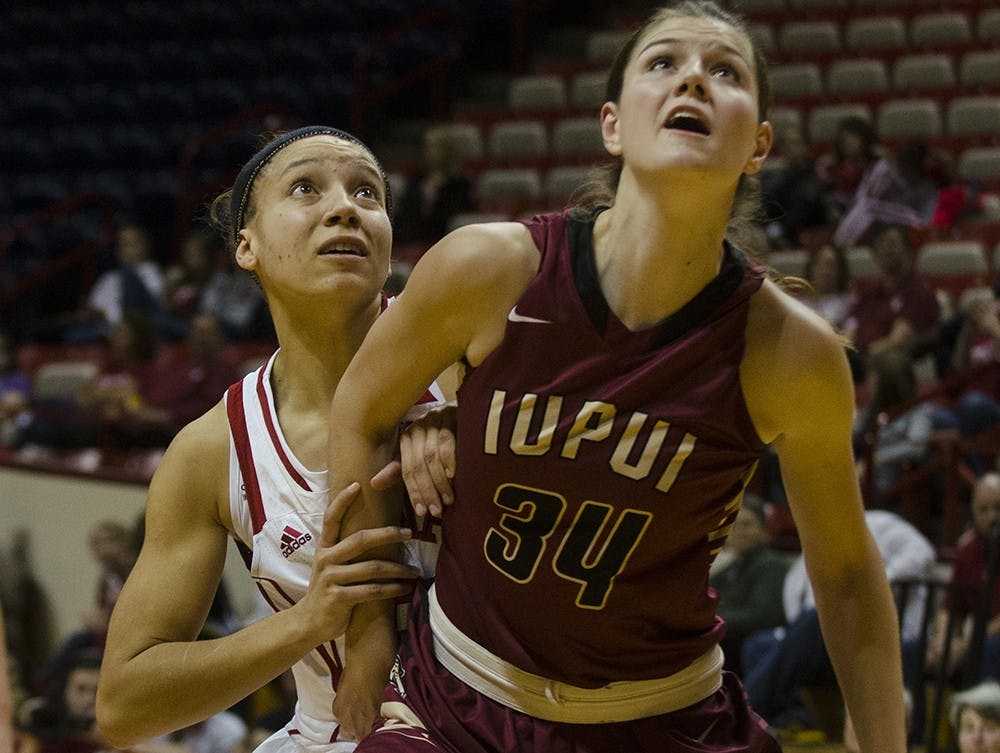 Sophomore guard Alexis Gassion and IUPUI forward Nevena Markovic wait for a rebound Sunday at Assembly Hall.  Indiana won 68-55 and will return to Assembly Hall next Wednesday to play Indiana University-Purdue University Fort Wayne (IPFW). 