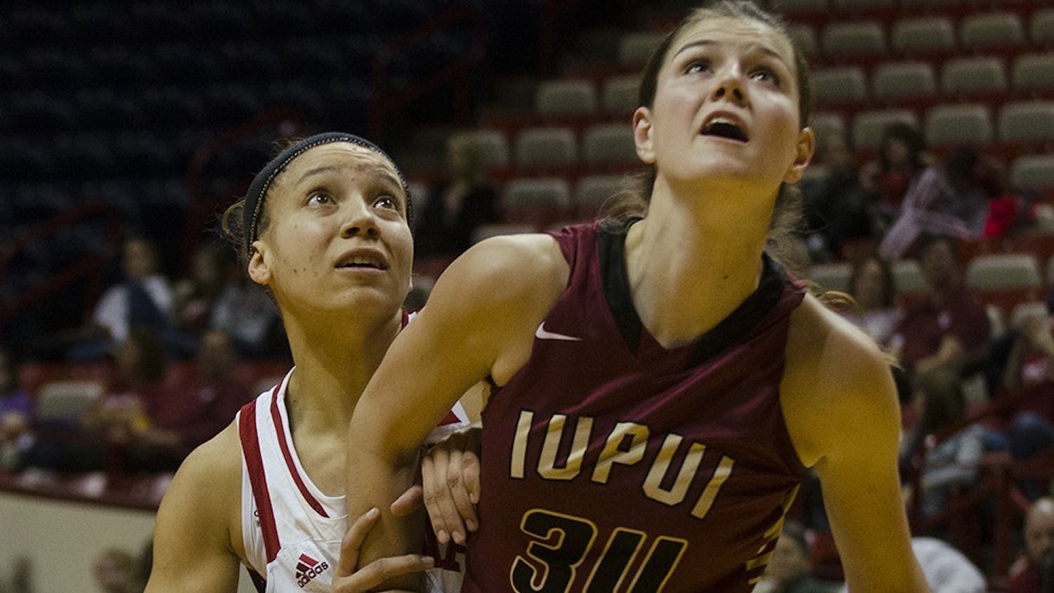 Sophomore guard Alexis Gassion and IUPUI forward Nevena Markovic wait for a rebound Sunday at Assembly Hall.  Indiana won 68-55 and will return to Assembly Hall next Wednesday to play Indiana University-Purdue University Fort Wayne (IPFW). 