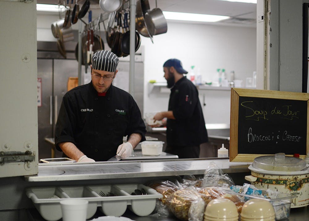 Brad Richardson, chef of the Alpha Epsilon Pi fraternity, prepares green pepper for the salad bar during lunchtime on Thursday at Alpha Epsilon Pi house located on Jordan Ave. Richardson has been a chef of the house for two years. He and his staff prepare three meals during weekdays and two meals during weekend for the students living in the house. Richardson said his work includes designing the menu on a weekly basis and cooking from scratch with fresh ingredients. 