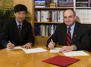 COURTESY PHOTOSungkyunkwan University President Jung-Don Seo and IU President Michael McRobbie sign an agreement to partner the two universities, allowing students from the South Korea university to attend both universities and receive two degrees.