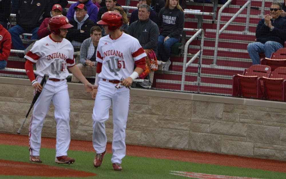 Sophomore Matt Lloyd and junior Logan Sowers congratulate each other after they both tagged home plate. They both hit singles, and&nbsp;senior Tony Butler hit a double to give the Hoosiers a 3-2 lead against the Evansville Aces.&nbsp;