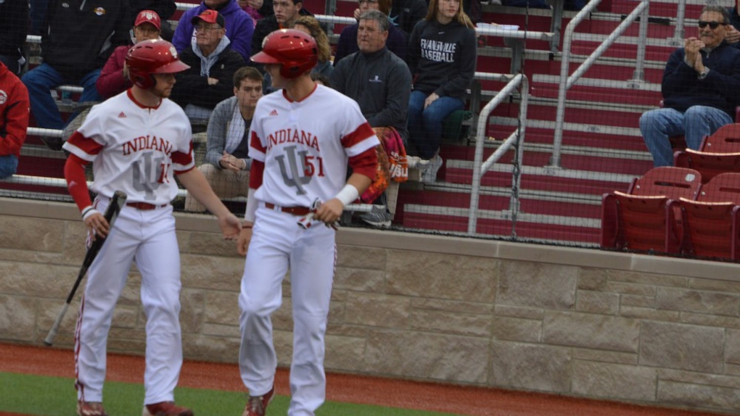 Sophomore Matt Lloyd and junior Logan Sowers congratulate each other after they both tagged home plate. They both hit singles, and&nbsp;senior Tony Butler hit a double to give the Hoosiers a 3-2 lead against the Evansville Aces.&nbsp;