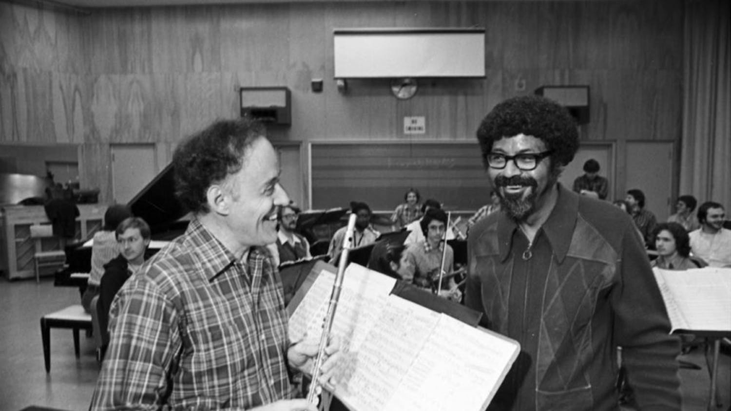An IU News Bureau release dated Nov. 18, 1982, accompanies this image. It reads, in part: "James Pellerite and David Baker go over the score for Baker's 'Concerto for Flute and Jazz Band,' which Pellerite will perform with the IU Jazz Ensemble, Monday, Nov. 22, at 8 p.m. in the Musical Arts Center...""