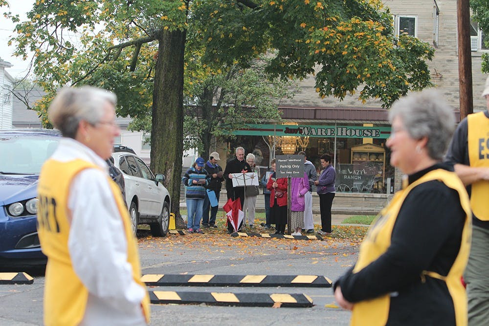 Escorts wait outside Planned Parenthood of Bloomington for women coming into the center for an abortion. Abortions occur on each Thursday and protestors wait outside for every opportunity to talk to the people going into the center.

Protestors pray and sing hymns as escorts wait for patients going into Planned Parenthood of Bloomington on one of the mornings abortions occur. 