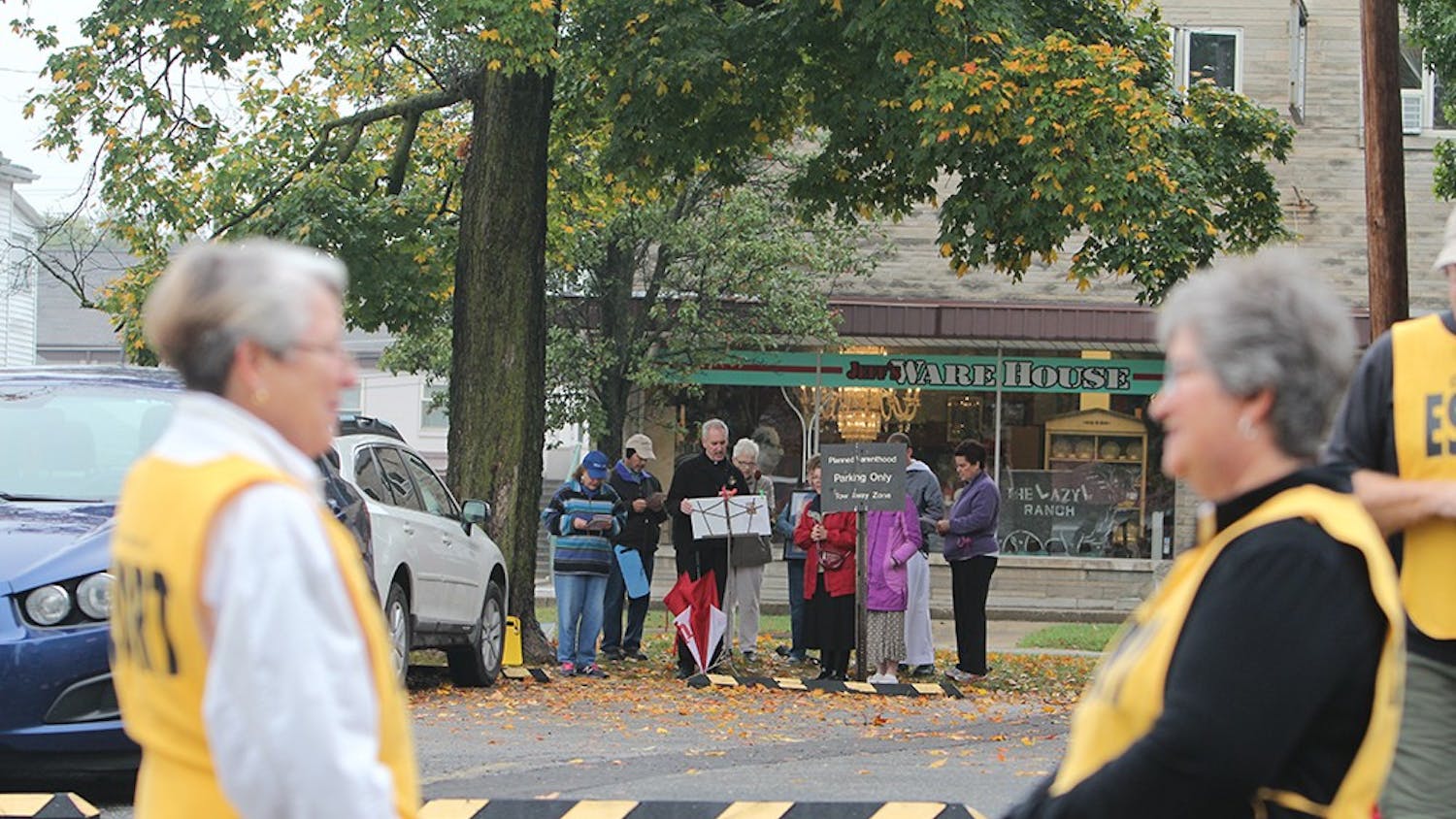 Escorts wait outside Planned Parenthood of Bloomington for women coming into the center for an abortion. Abortions occur on each Thursday and protestors wait outside for every opportunity to talk to the people going into the center.

Protestors pray and sing hymns as escorts wait for patients going into Planned Parenthood of Bloomington on one of the mornings abortions occur. 