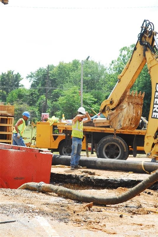 City of Bloomington utility employees work to fix the broken water main at 10th Street and the 45/46 bypass on Wednesday afternoon.