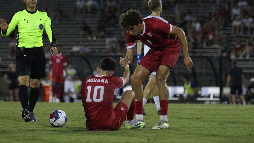 Junior forward Tommy Mihalic (left) is helped up by senior defender Hugo Bacharach (right) after a foul against Seton Hall University on Sept. 4, 2023, at Bill Armstrong Stadium in Bloomington. Bacharach returned to action Friday after a two-game absence.