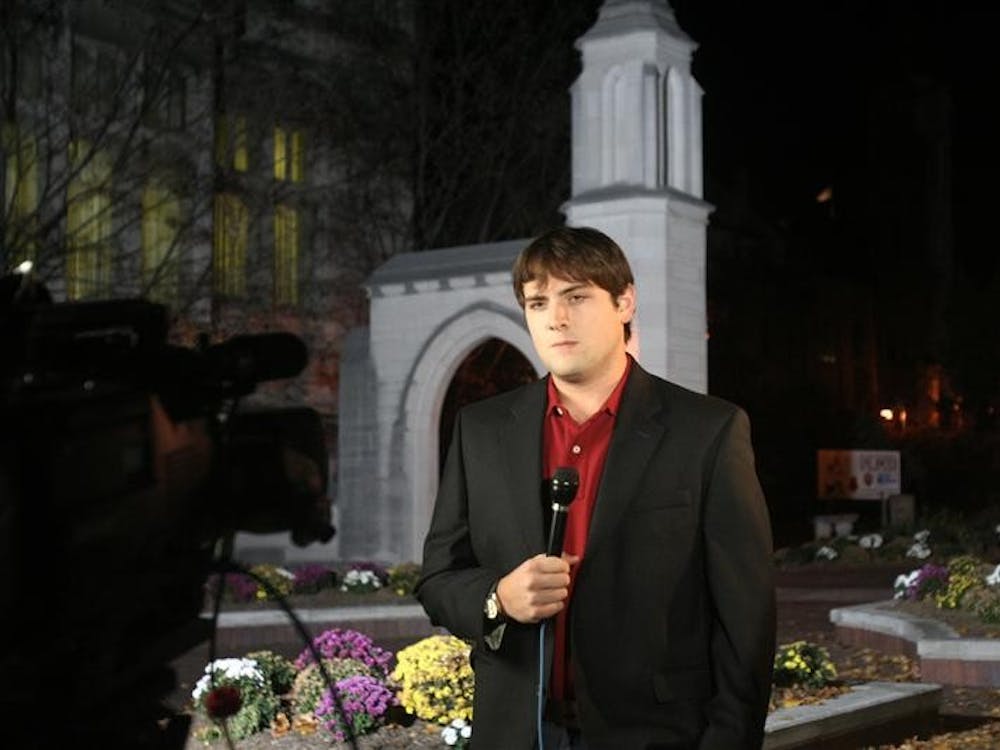 Luke Russert, NBC correspondent, prepares to do a live stand up for the "NBC Nightly News with Brian Williams" on Monday night in front of the Sample Gates. Russert will be on campus today filming live segments for NBC's "Today Show" and other election coverage.