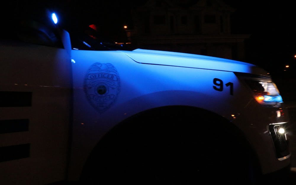 An IUPD police car sits idly behind a routine traffic violation. IUPD's night shift runs from 6 p.m. to 6 a.m.