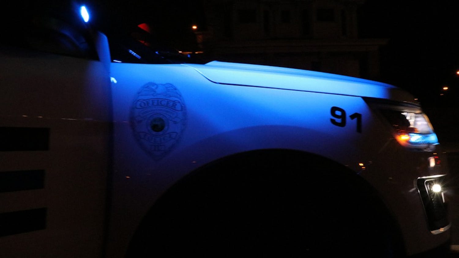 An IUPD police car sits idly behind a routine traffic violation. IUPD's night shift runs from 6 p.m. to 6 a.m.