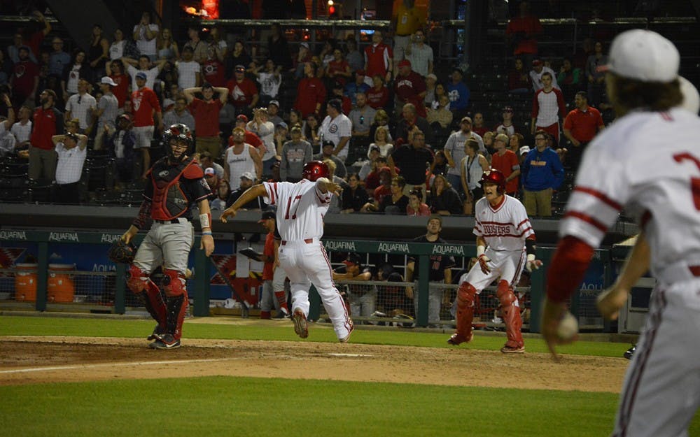 Junior Laren Eustace steps on home plate to score the winning run for the Hoosiers Tuesday evening at Victory Field in Ind. The game ended 4-3. 
