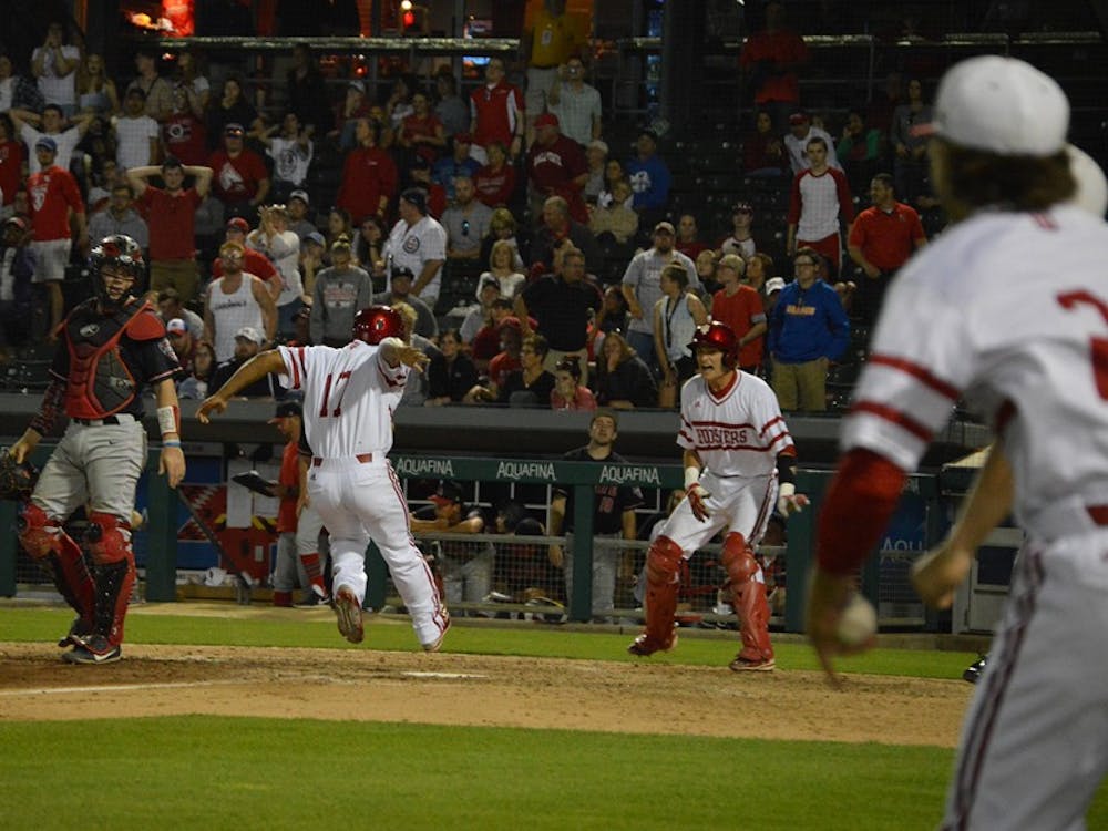 Junior Laren Eustace steps on home plate to score the winning run for the Hoosiers Tuesday evening at Victory Field in Ind. The game ended 4-3. 