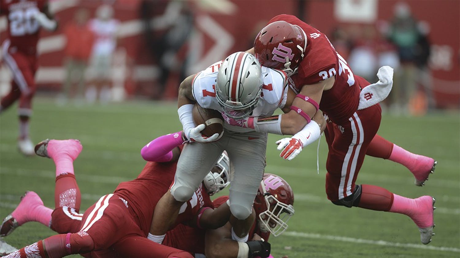 Linebacker Zeke Walker (6) and Oliver Marcus (44) and safety Chase Dutra (30) tackles Ohio State's Jalin Marshall (7) on Oct. 3 at Memorial Stadium. The Hoosiers lost to the number one ranked Buckeyes, 27-34.