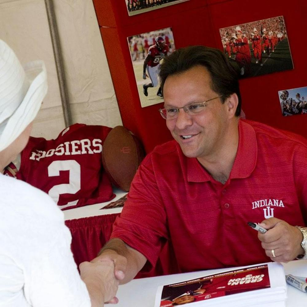 IU Men's Basketball coach Tom Crean shakes hands with a fan during an autograph session as a part of IU Day on Thursday at the Indiana State Fair in Indianapolis. Crean signed over a hundred autographs before giving a speech during a pep rally at the fairgrounds.