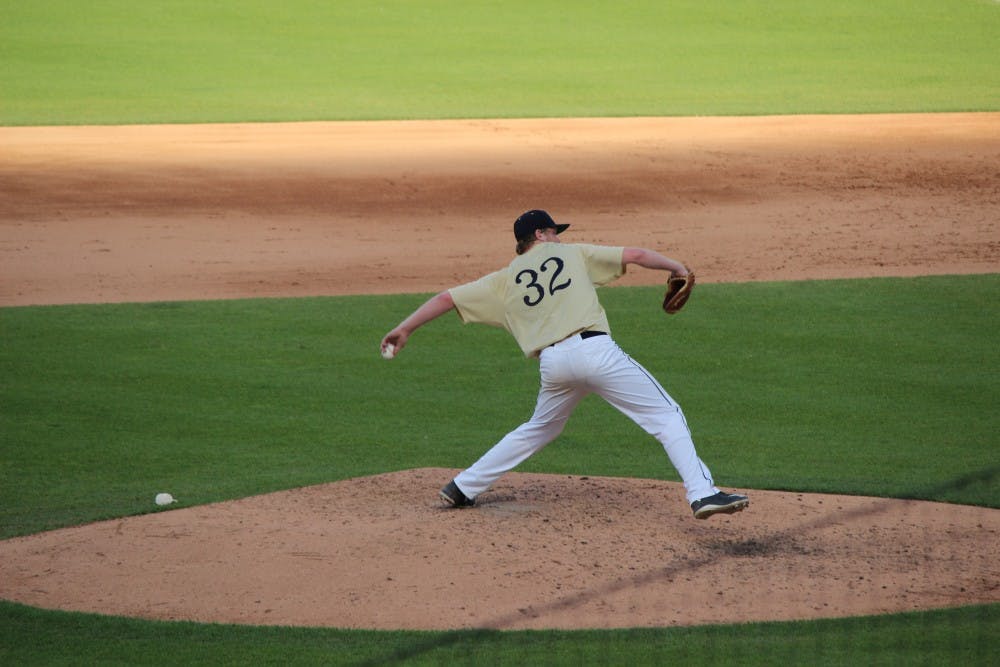 Incoming freshman pitcher Nick Eaton throws a pitch in the 4A State Championship game. Eaton helped Cathedral High School defeat Penn High School 4-3 in extra innings to complete the perfect season by the Irish.