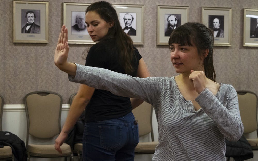 Carmen Vernon, senior, practices a self defense move at the Feminist Student Association meeting Thursday evening. The IU Hapkido / Self Defense Club gave demonstrations on self defense techniques. 