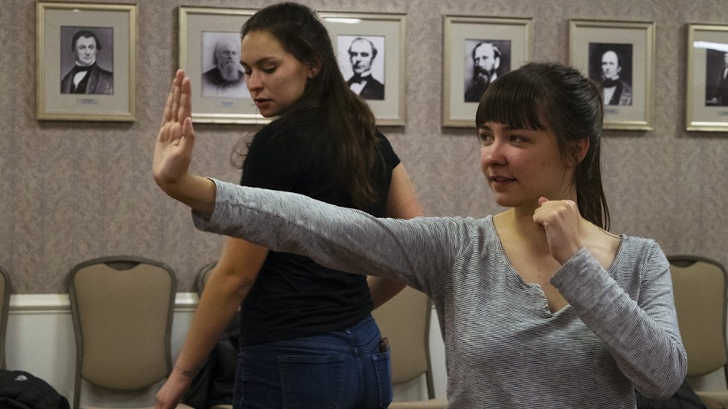 Carmen Vernon, senior, practices a self defense move at the Feminist Student Association meeting Thursday evening. The IU Hapkido / Self Defense Club gave demonstrations on self defense techniques. 
