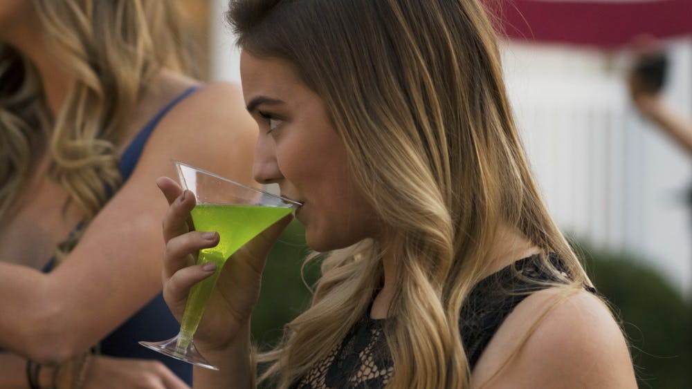 Katie Peck, a junior, sips a nonalcoholic appletini at the Delta Zeta Mocktail Night on Wednesday. The event aimed to show how people can have a good time without drinking alcohol.