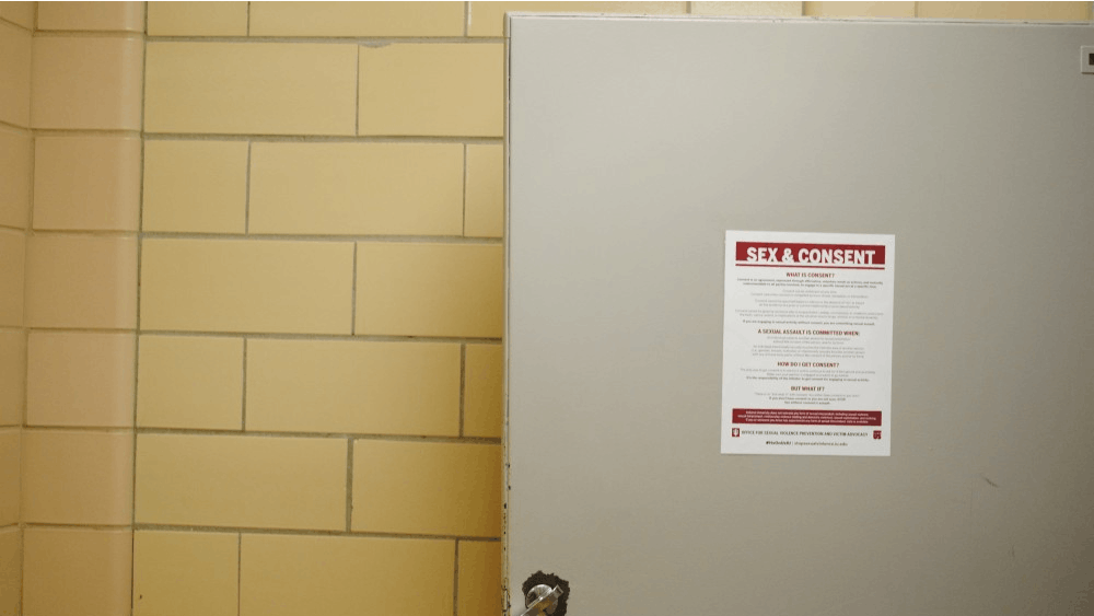 IU plasters flyers, like this one in Ballantine Hall, in nearly every bathroom stall on campus, reminding students of what it means to ask for and give consent. Lawyers for those accused of sexual assault in the University's system say IU's definitions of consent are too simplistic.